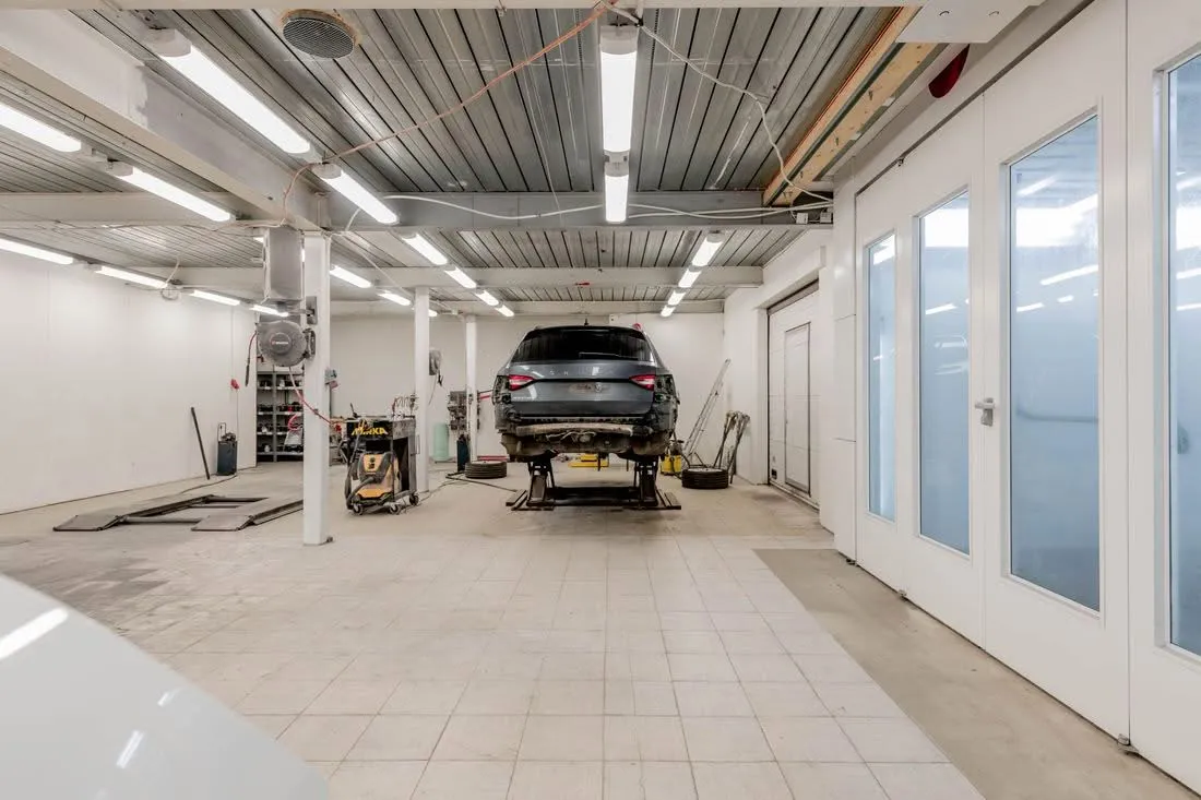 Auto sollevata sul ponte idraulico in officina, pronta per il tagliando